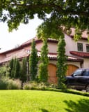 Slender Silhouette Sweet Gum with narrow columnar foliage in a landscaped residential yard